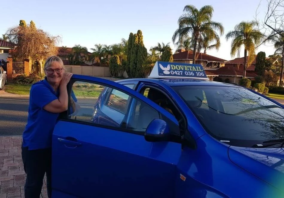 Lisa Archer beside the Dovetail Driving car
